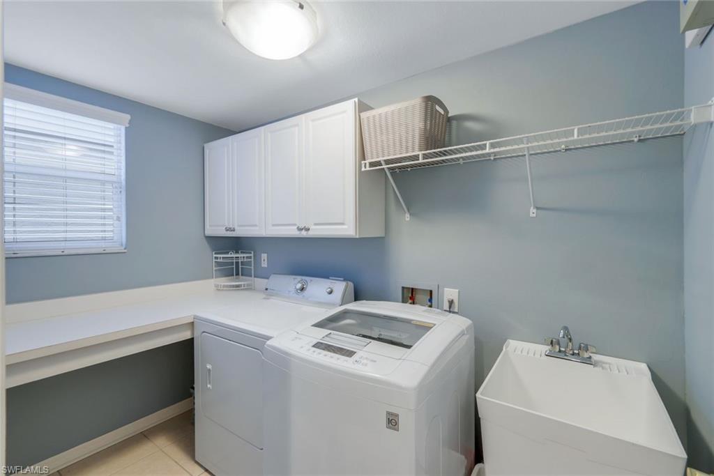 17896 Modena Road Miromar Lakes, FL 33913 - Photo 24 of 38 Laundry room featuring folding and hanging areas, cabinets, separate washer and dryer, window and sink