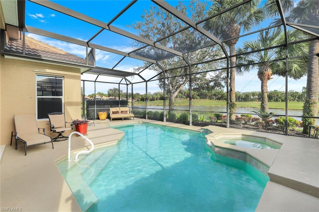 17896 Modena Road Miromar Lakes, FL 33913 - Photo 27 of 38 View of furnished pool area featuring gas heated hot tub, overlooking water and golf course