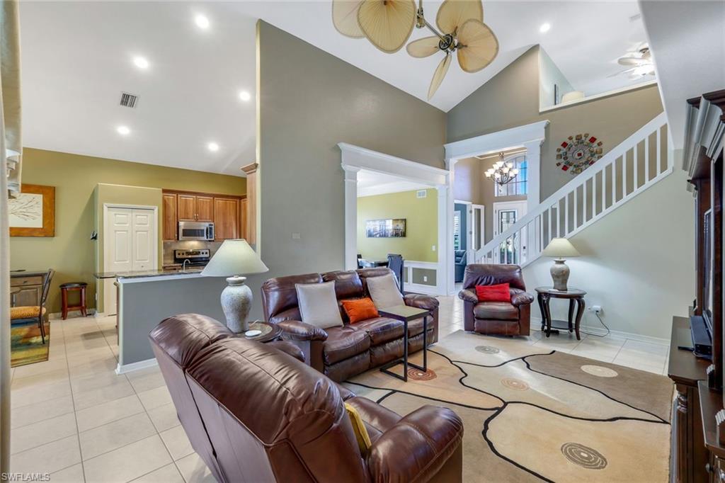 17896 Modena Road Miromar Lakes, FL 33913 - Photo 3 of 38 Grand room featuring fan-a-mation fan, high vaulted ceiling. Home sold furnished with couple exclusions.