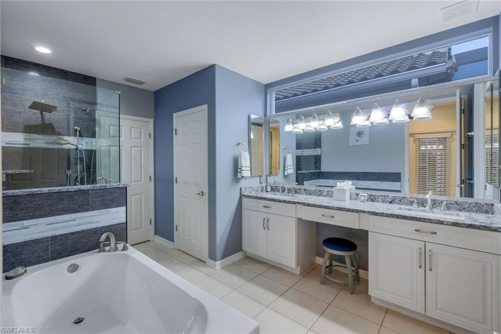 17896 Modena Road Miromar Lakes, FL 33913 - Photo 8 of 38 Updated master Bathroom featuring walk in shower, vanity, soaker tub.