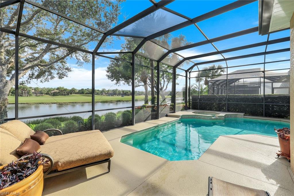 17896 Modena Road Miromar Lakes, FL 33913 - Photo 10 of 38 Pool featuring a water view, an in ground hot tub, screened lanai, and a lounging patio area