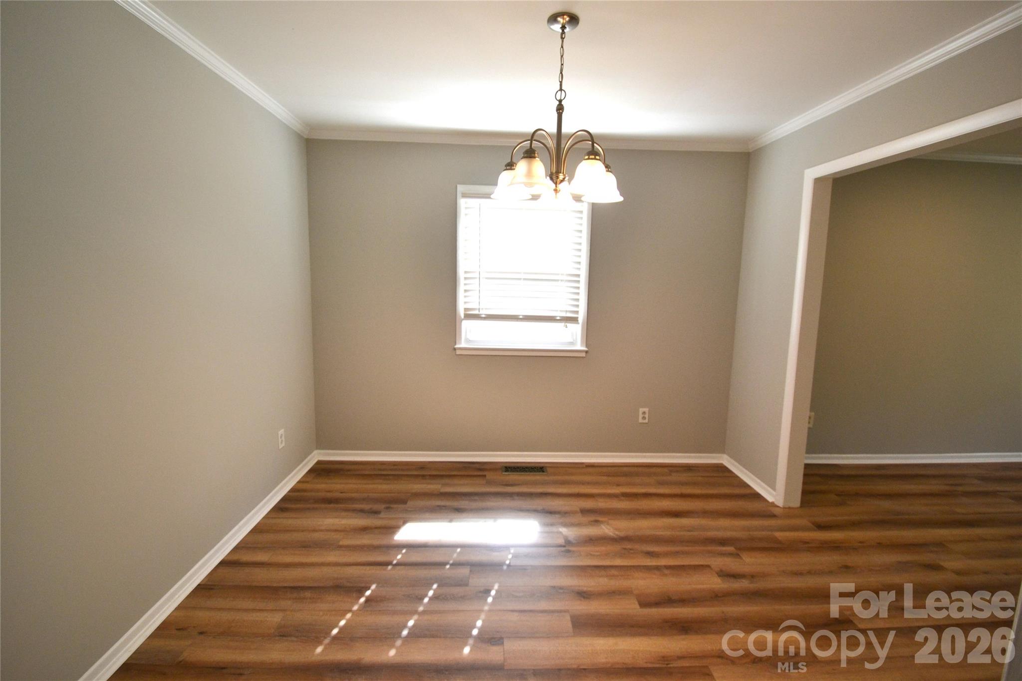 1422 Thermal Road Charlotte, NC 28212 - Photo 6 of 40 a view of wooden floor and a chandelier in a room