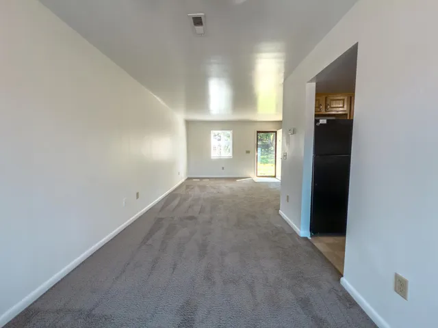 an empty room with windows and closet