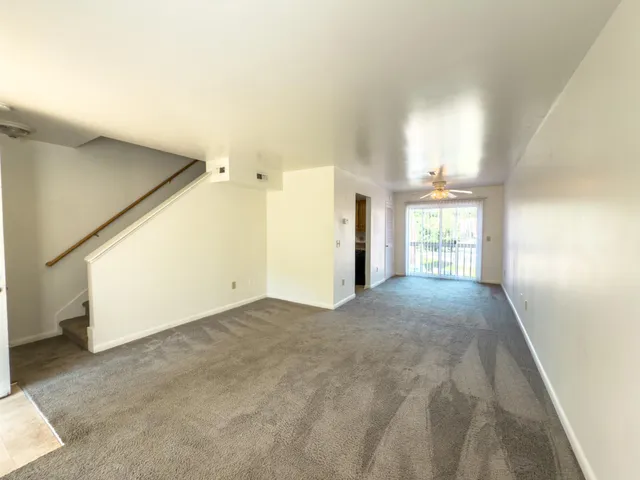 a view of an empty room and a window