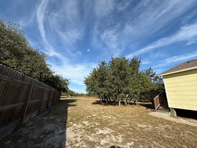 a view of a backyard of the house