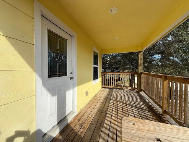 a view of balcony with wooden floor