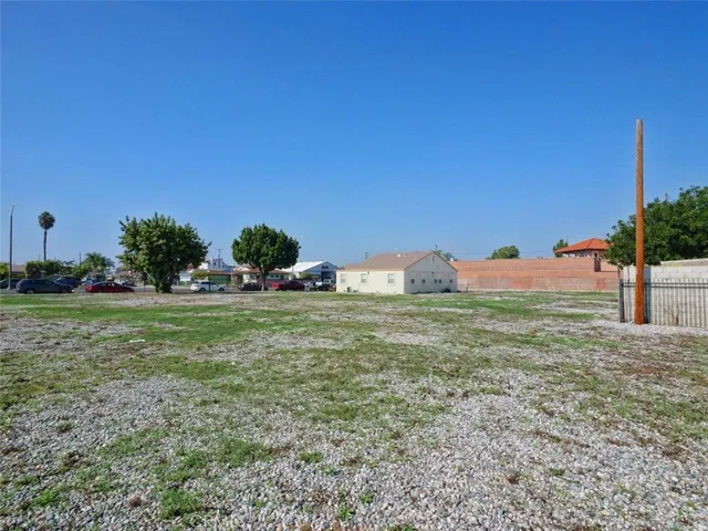 a view of a field with of house in background