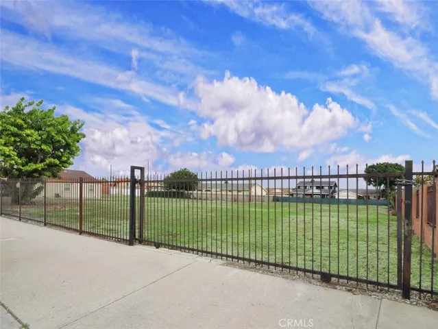 a view of house with swimming pool and outdoor seating