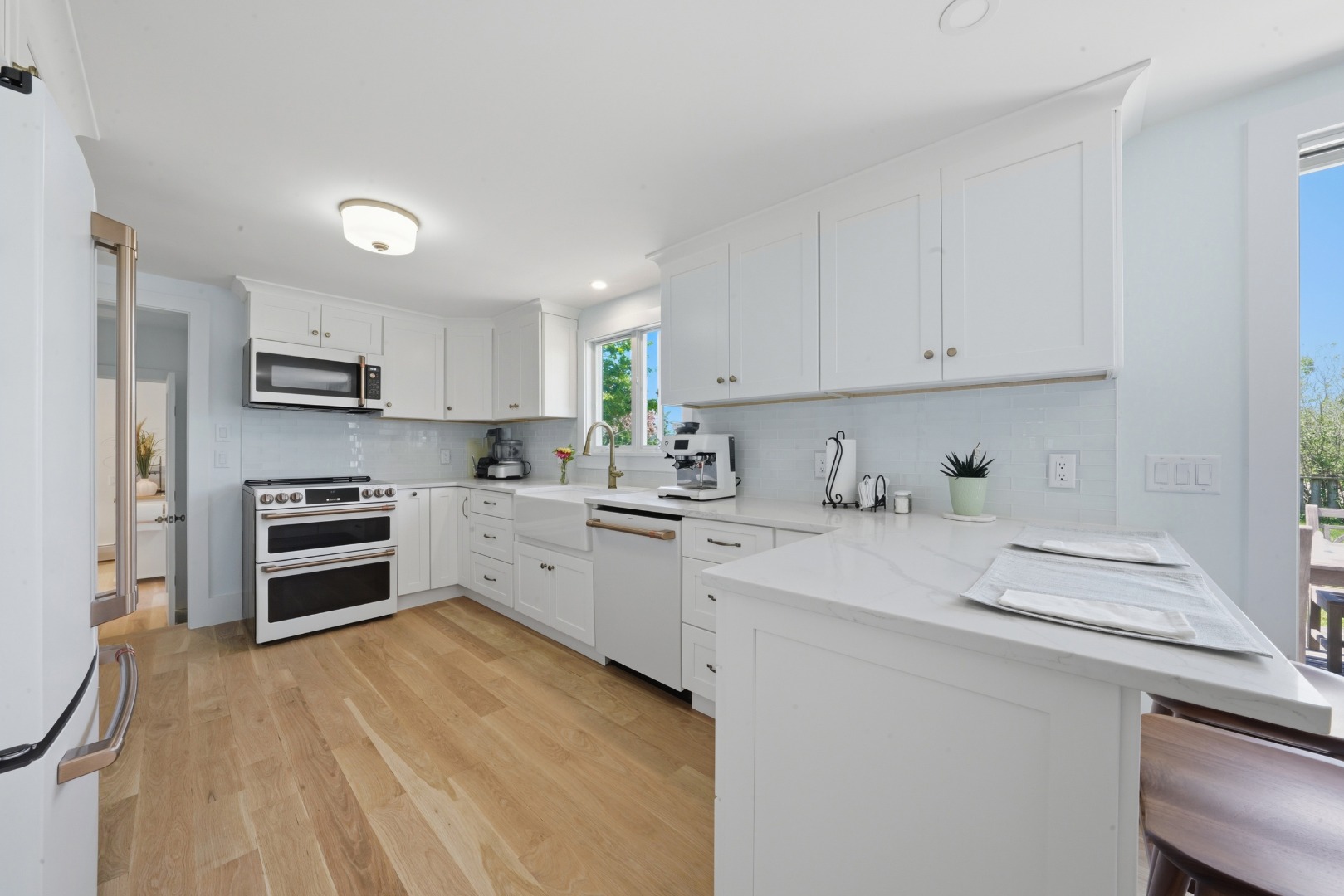 a kitchen with granite countertop a stove sink and cabinets