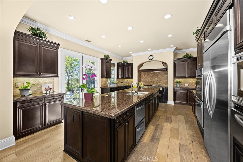 19668 Three Oaks Lane Walnut, CA 91789 - Photo 14 of 45 a kitchen with stainless steel appliances granite countertop a stove refrigerator and a sink
