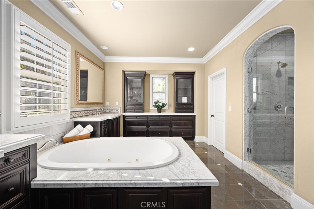 19668 Three Oaks Lane Walnut, CA 91789 - Photo 22 of 45 a bathroom with a granite countertop tub a sink and a large mirror