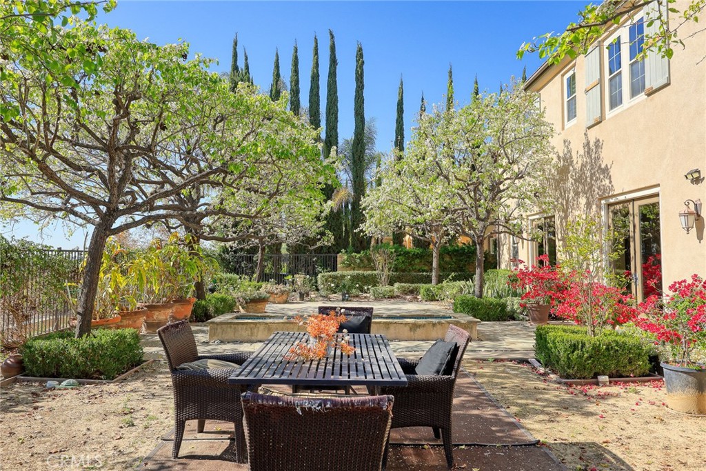 19668 Three Oaks Lane Walnut, CA 91789 - Photo 36 of 45 a view of a patio with table and chairs and potted plants