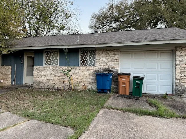 a front view of a house with a garden and yard
