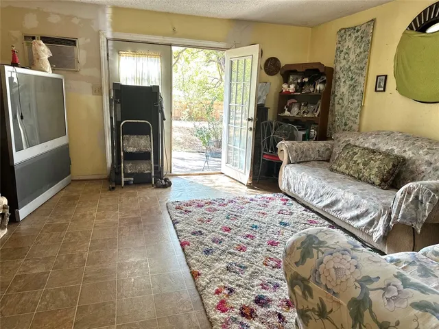 a living room with a couch and a dresser next to a window