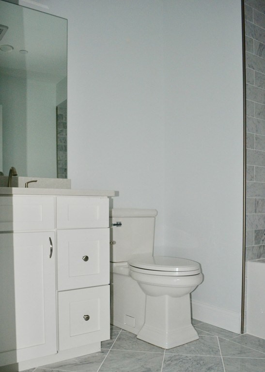 728 East Broadway, Unit 404 Boston, MA 02127 - Photo 7 of 10 a bathroom with a toilet and a sink