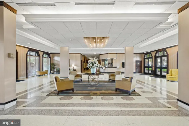 a view of a living room with a lots of white furniture