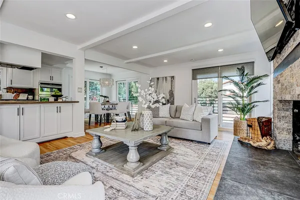 a living room with furniture a flat screen tv and a fireplace