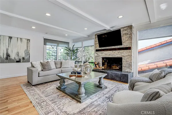 a living room with furniture flat screen tv and a fireplace