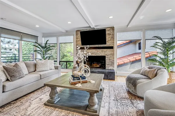 a living room with furniture a flat screen tv and a fireplace