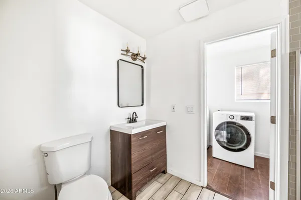 a bathroom with a toilet sink and mirror