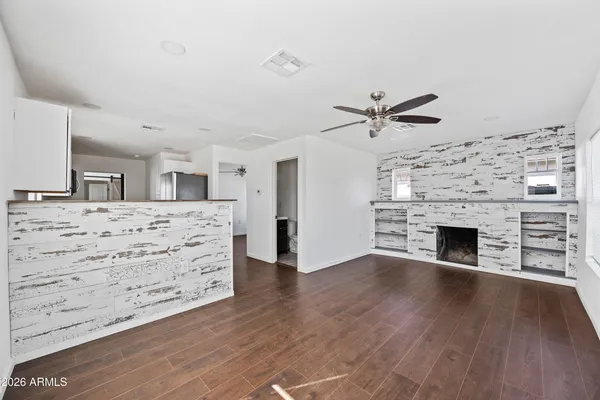 an empty room with cabinet and a fireplace