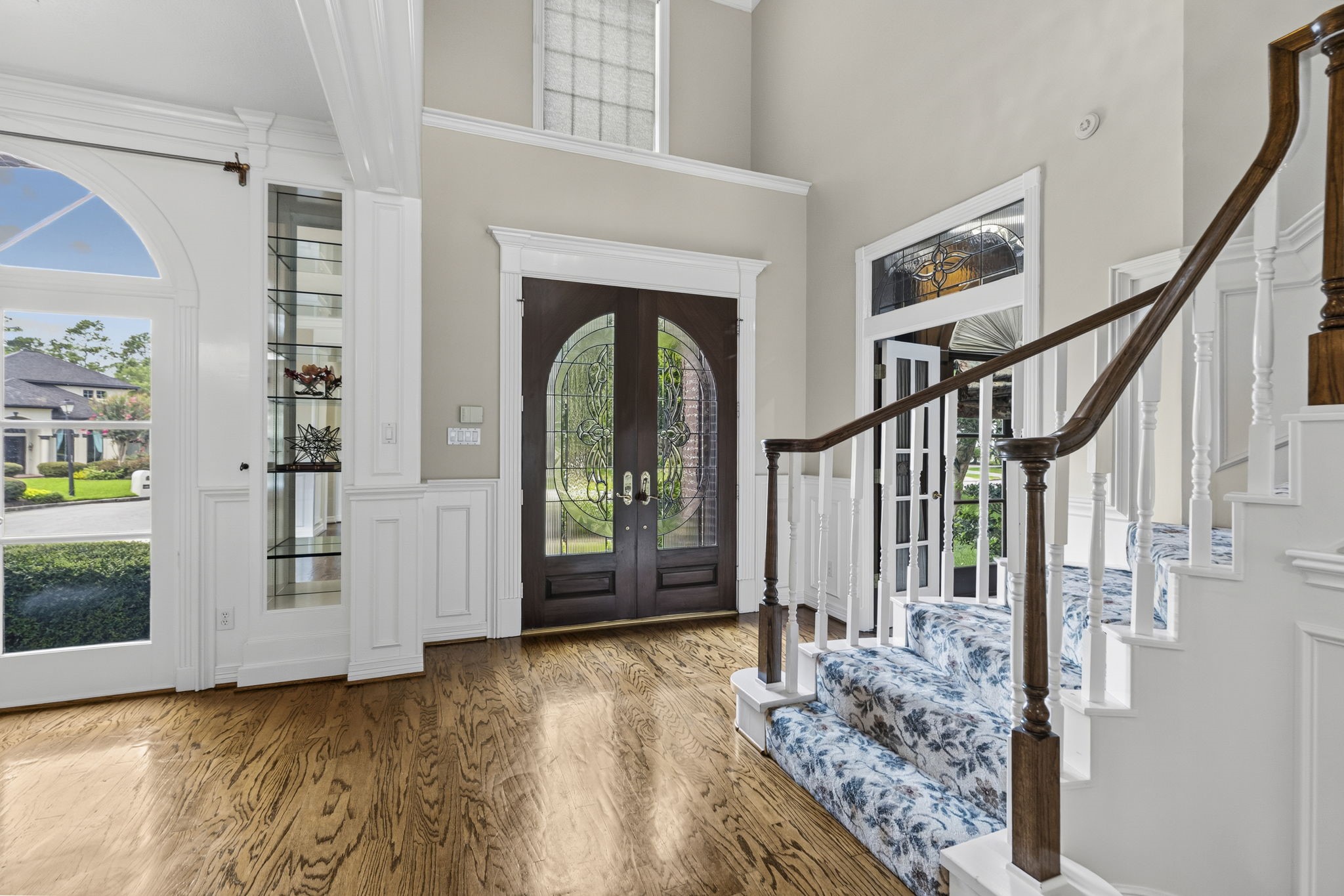 18310 Pamela Way Spring, TX 77379 - Photo 4 of 42 French doors and transoms grace the entry, allowing for an abundance of natural light to flood the foyer and illuminate the inviting open-concept living.