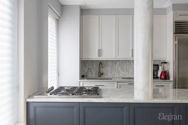 a kitchen with stainless steel appliances granite countertop a sink and cabinets
