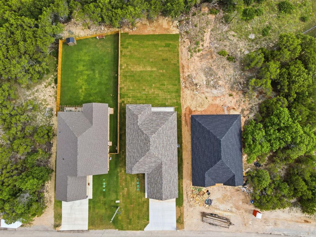 1413 Ridgeview Circle Granbury, TX 76048 - Photo 34 of 35 Aerial perspective showcasing three distinct properties, each featuring a shingle roof