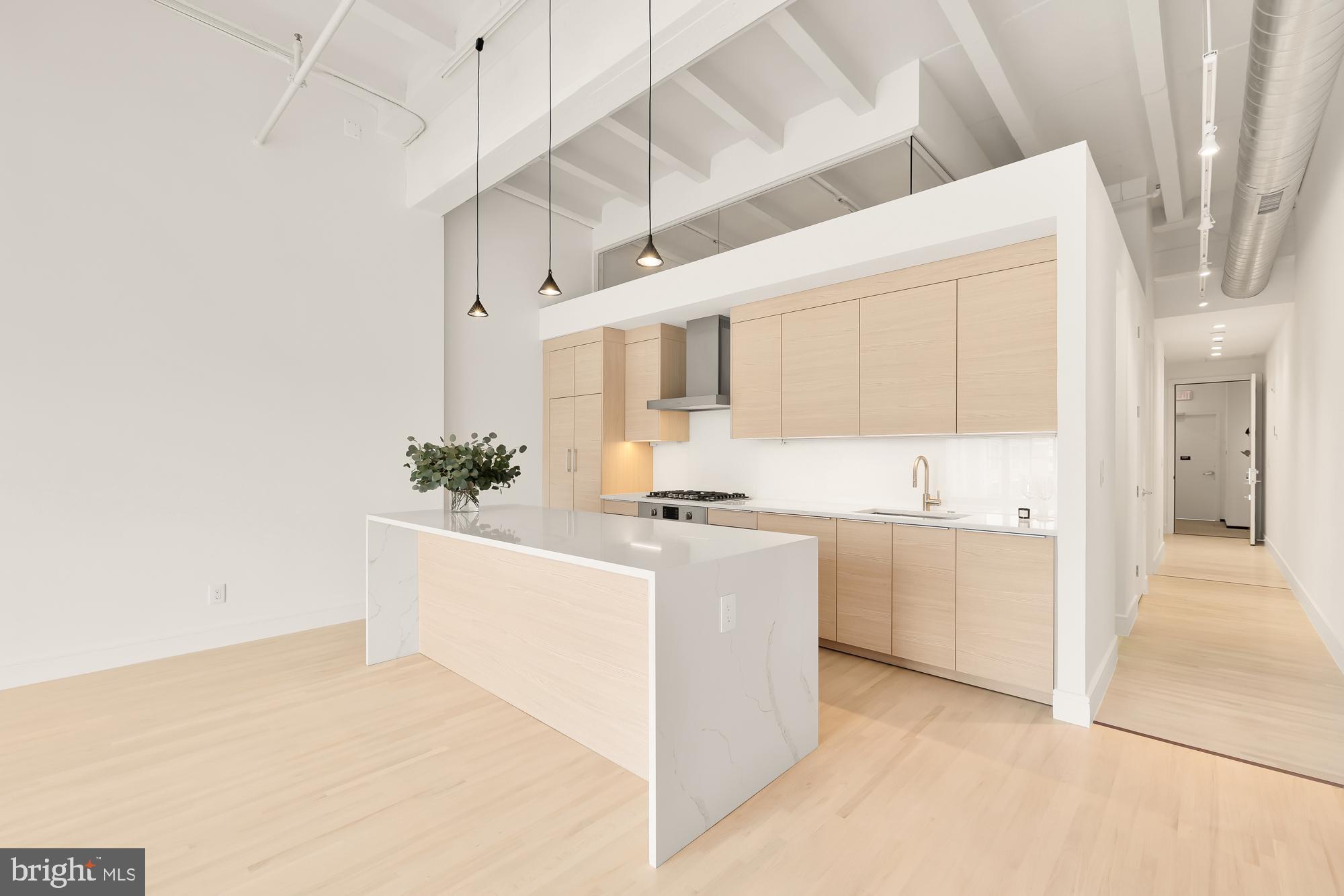1515 14th Street Northwest, Unit 302 Washington, DC 20005 - Photo 1 of 28 a large white kitchen with cabinets