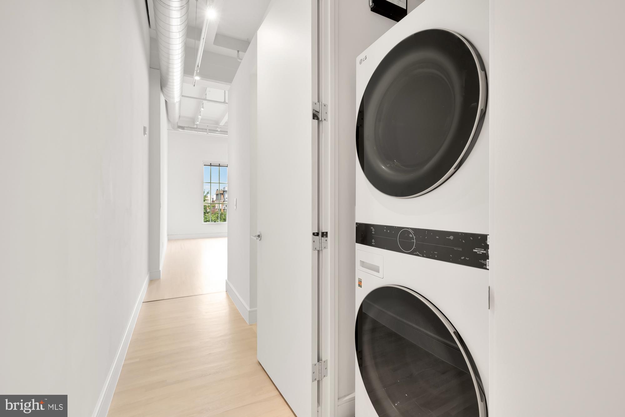 1515 14th Street Northwest, Unit 302 Washington, DC 20005 - Photo 11 of 28 a view of a hallway with washer and dryer