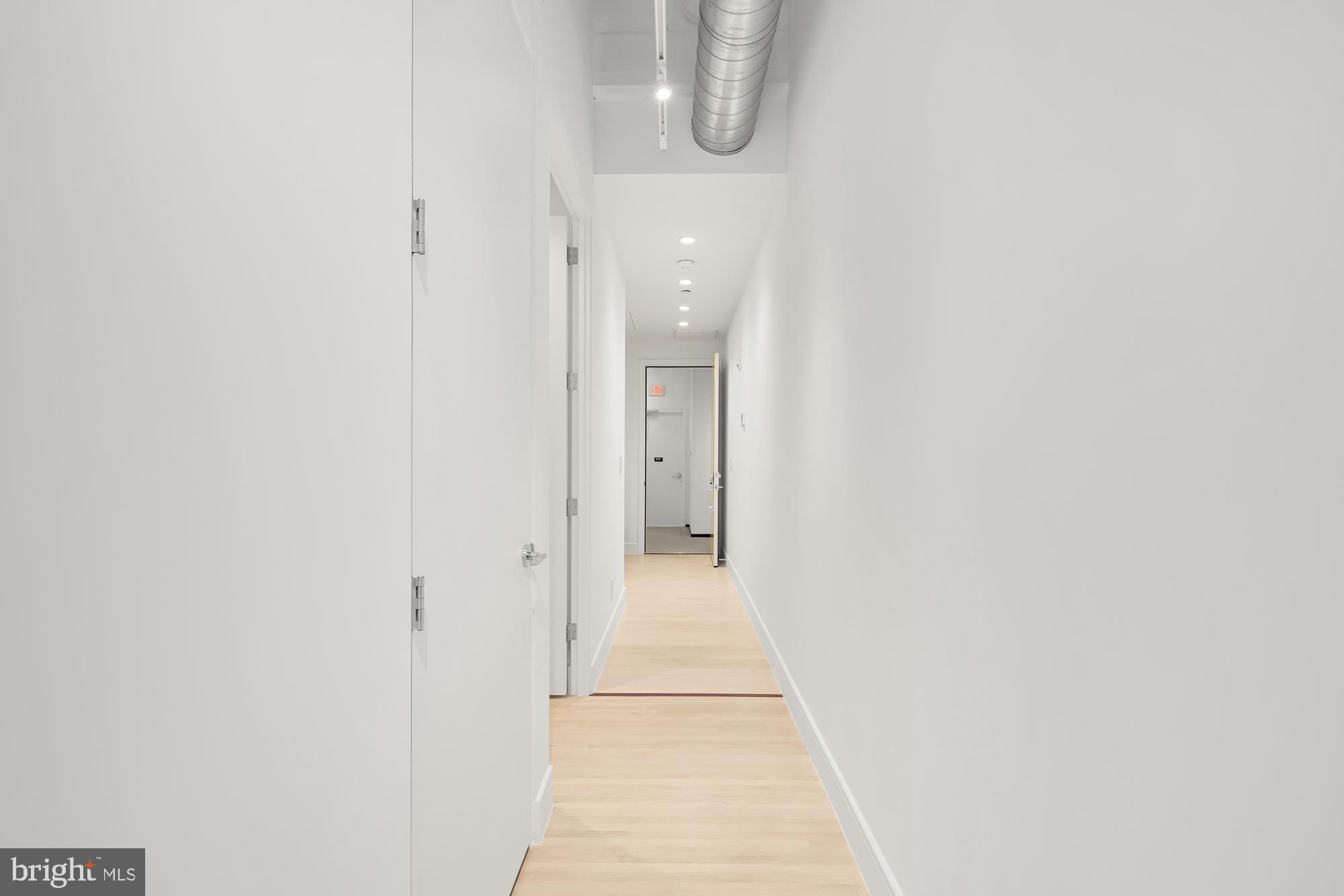 1515 14th Street Northwest, Unit 302 Washington, DC 20005 - Photo 13 of 28 a view of a hallway with wooden floor and a bathroom