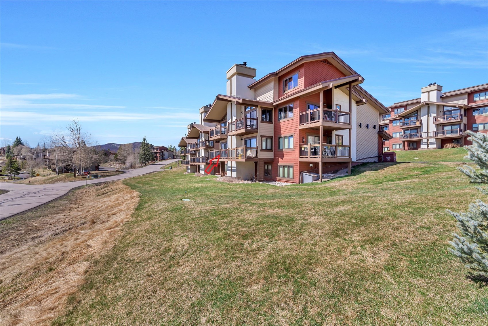 1720 Ranch Road, Unit 309 Steamboat Springs, CO 80487 - Photo 26 of 43 a view of a big house with a big yard and large trees