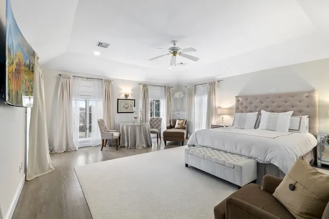 a spacious bedroom with a bed couch and window