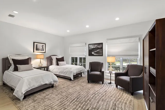 a bedroom with two beds and a couch