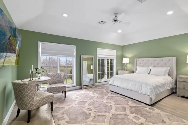 a bedroom with a large bed and a large window