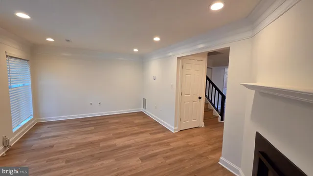 an entryway in a hall with wooden floor