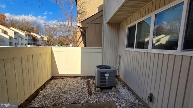 a view of a house with backyard and wooden fence