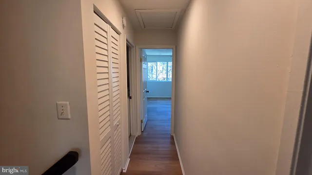 a view of a hallway with wooden floor
