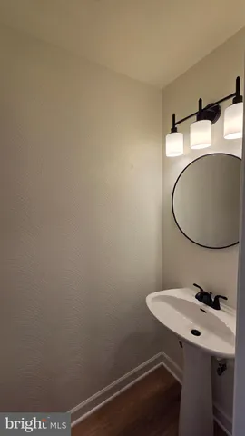 a bathroom with a sink a mirror and a toilet