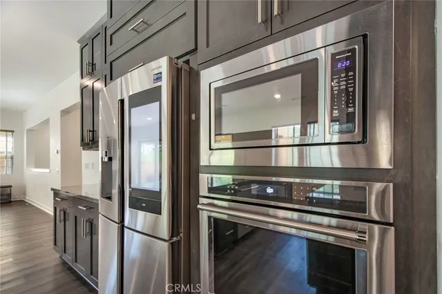 a kitchen with stainless steel appliances granite countertop a stove and a refrigerator