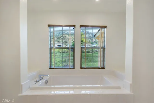 a bathroom with a bathtub and a window