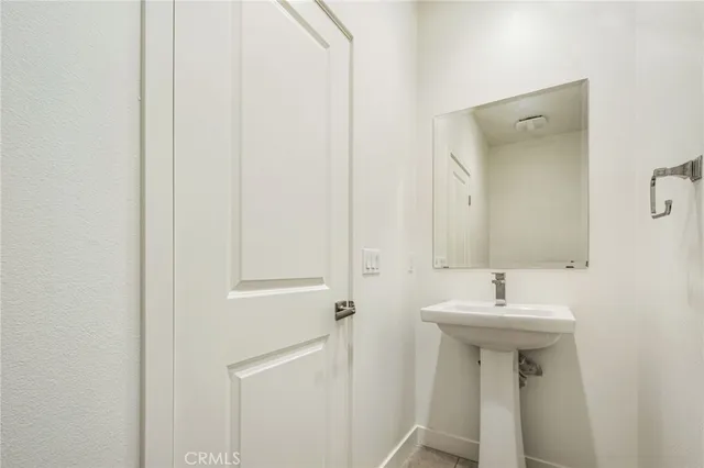 a bathroom with a sink a mirror and a toilet