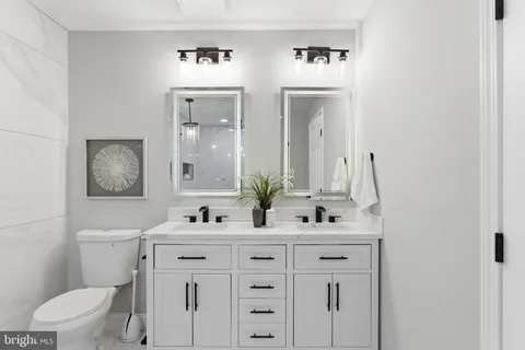 a bathroom with a double vanity sink and a mirror