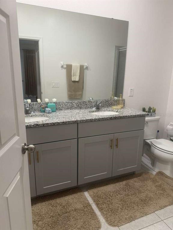 570 Feltrim Manor Road Haines City, FL 33844 - Photo 11 of 18 a bathroom with a granite countertop sink and a mirror