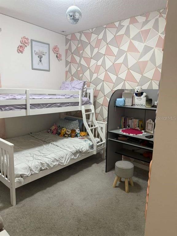 570 Feltrim Manor Road Haines City, FL 33844 - Photo 12 of 18 a bedroom with a bed and a dresser