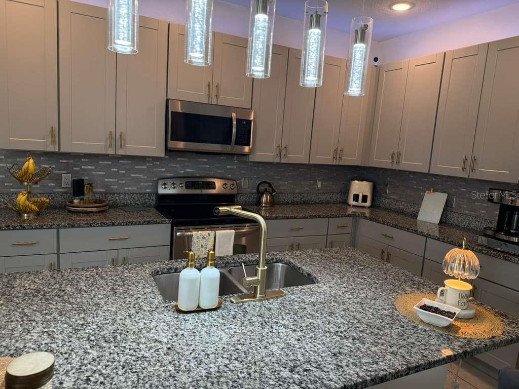 570 Feltrim Manor Road Haines City, FL 33844 - Photo 2 of 18 a kitchen with a sink and a stove top oven