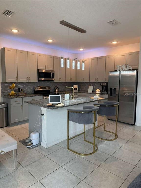 570 Feltrim Manor Road Haines City, FL 33844 - Photo 5 of 18 a kitchen with a sink cabinets and stainless steel appliances