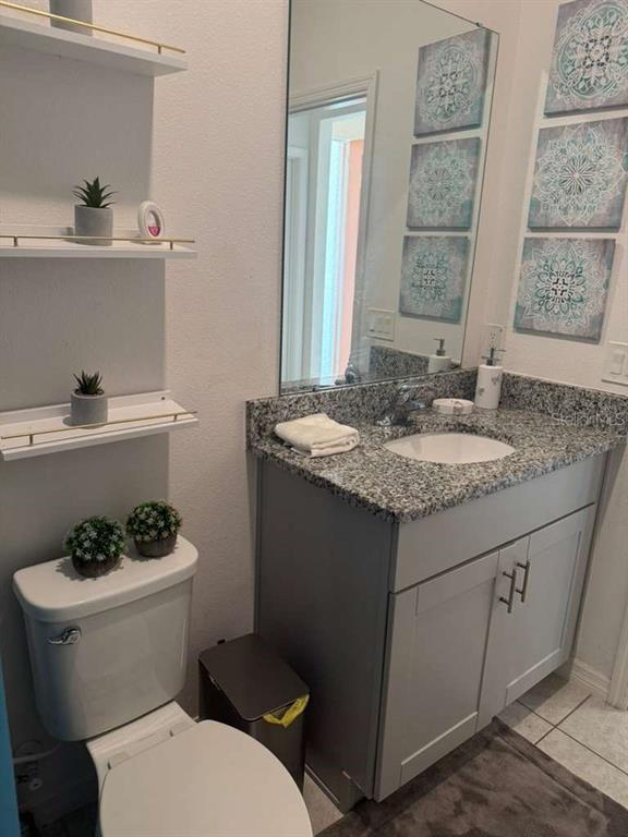 570 Feltrim Manor Road Haines City, FL 33844 - Photo 9 of 18 a bathroom with a granite countertop toilet sink and mirror
