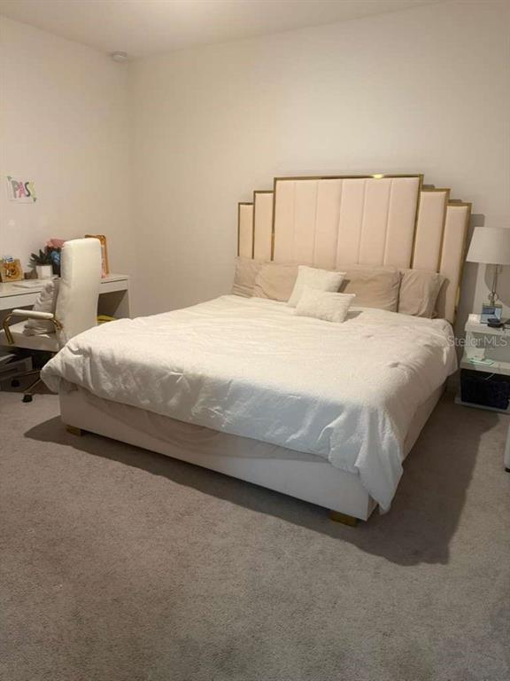 570 Feltrim Manor Road Haines City, FL 33844 - Photo 10 of 18 a large bed sitting in a bedroom next to a lamp