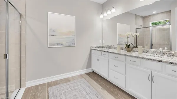 a bathroom with a double vanity sink and a mirror